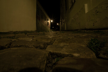 .light from the street lights and sidewalk with cobblestones at night in the center of prague czech...