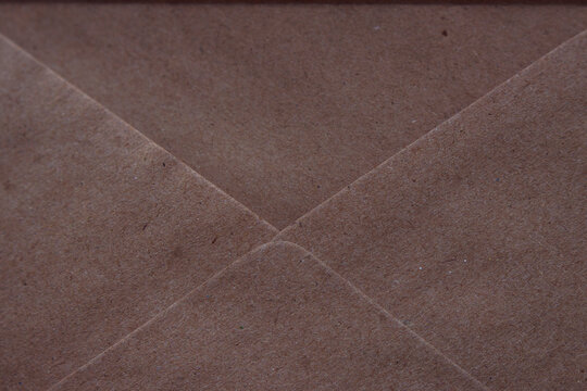 opened envelope which is made from recycled paper - close up, textured paper background, message and letter