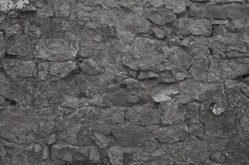 gray background. in the photo, the stone wall of the old building