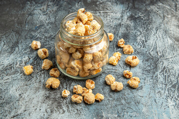 front view sweet popcorn inside glass can on light background snack movie sugar