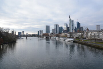 Fototapeta na wymiar View on Frankfurts Skyline, seen from a bridge over the river Main