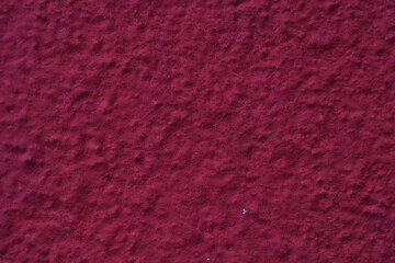 cement rough wall with red paint - close up outdoors, textured background for message,  announcement