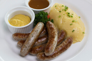 Six Bavarian grilled Nuremberg sausages served with potato mash, dark beer jus and mustard
