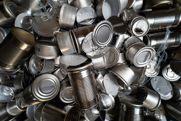 Metal tins, cans and jar garbage from household on the table. City home trash made of aluminum. Empty used, food and drink steel packaging waste and scrap discarded sorted and ready to recycle.