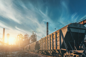 Blast furnace of metallurgical plant with industrial railroad and freight wagons 