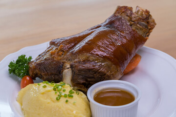 Bavarian grilled pork knuckle served with potato mash and dark beer sauce