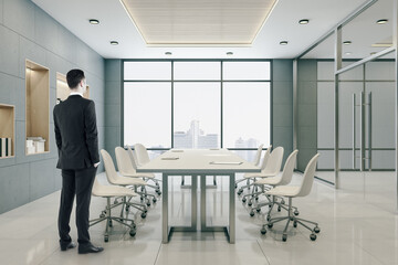 Businessman standing in modern conference room