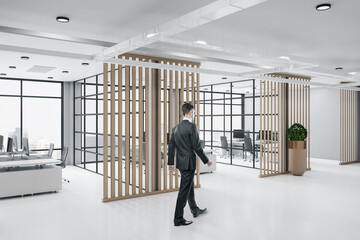 Fototapeta premium Businessman walking in loft style wooden ceo interior