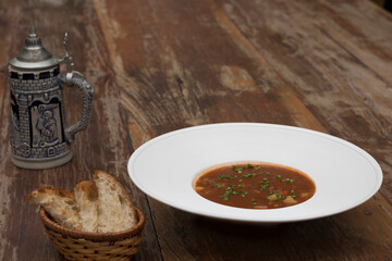 Hearty beef goulash soup served with toasted bread