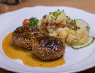 Pan-fried meatballs served with Bavarian potato cucumber salad