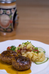 Pan-fried meatballs served with Bavarian potato cucumber salad