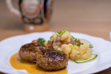 Pan-fried meatballs served with Bavarian potato cucumber salad