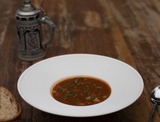 Hearty beef goulash soup served with toasted bread