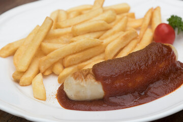 Currywurst, Berlin style grilled sausage served with ketchup and curry sauce