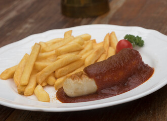 Currywurst, Berlin style grilled sausage served with ketchup and curry sauce