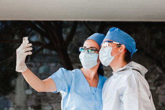 couple of latin women doctors taking a photo selfie with a smartphone in a Mexican hospital in Mexico or Latin America