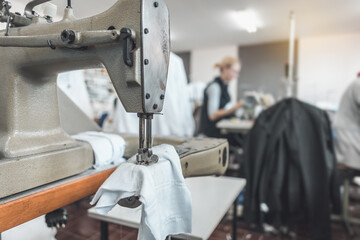 workers working on sewing machines in clothing industry