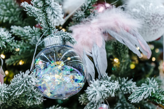 New year and Christmas reeting card with transparent balloon on a spruce branch 