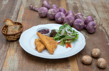 Baked feta cheese served with mixed salad and cranberry jam