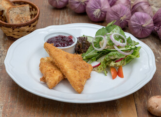 Baked feta cheese served with mixed salad and cranberry jam