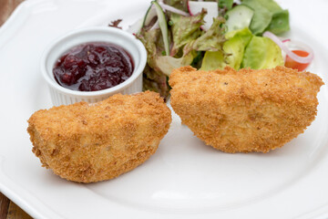 Baked Camembert cheese with mixed leaves and cranberry jam