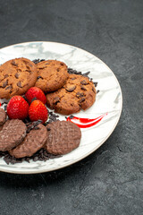 front view delicious choco biscuits for tea inside plate on dark background sweet cookies cake