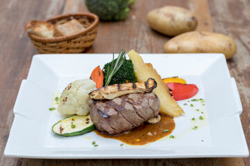 Chargrilled beef tenderloin with mixed vegetables, potato gratin and mushroom sauce