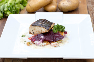 Pan-fried black cod on sautéed beetroot and potatoes with horseradish cream 