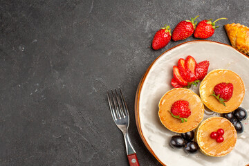 top view delicious pancakes with fruits on dark floor pie fruit cake sweet
