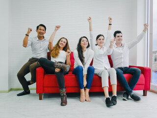 Fototapeta premium Friends cheering on sports from the television in the room, the mood of the winning supporters, everyone was happy