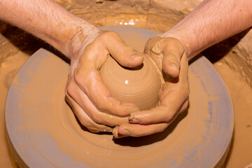 Male Hands Ceramics Maker working with Pottery Wheel