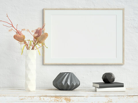 Mock up poster frame on white plaster wall with flowers in a ceramic vase, books and geometric vases on old wooden table; landscape orientation; stylish frame mock up; 3d rendering, 3d illustration