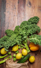 Fresh kale with other vegetables on a wooden table