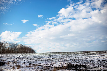 Empty not plowed field after winter blizzard at sunset. Winter rural scene.