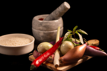 ingredients of the red thai curry on a board with black  background 