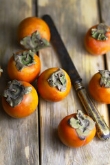 Persimmon on a wooden surface.