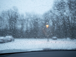 parking lot covered with snow through the windshield in winter