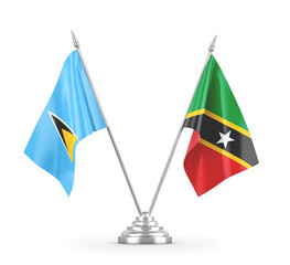 Saint Kitts and Nevis and Saint Lucia table flags isolated on white 3D rendering