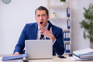 Sick male employee suffering at workplace