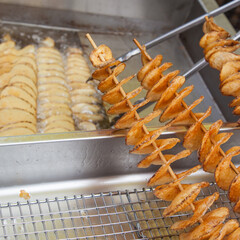 Street food-deep fried spiral potato (chips on a stick) 