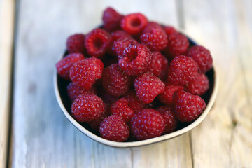 Fresh juicy raspberries in a bowl. Dessert berry raspberry.