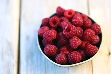 Fresh juicy raspberries in a bowl. Dessert berry raspberry.