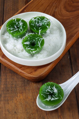 Kue Lumpang Pandan, kue ijo or kuih lompang. Traditional rice flour, tapioca and pandanus steamed cupcake from Indonesia