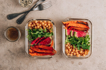Vegan healthy meal prep containers. Chickpeas, sweet potatoes, arugula, radish and avocado for lunch
