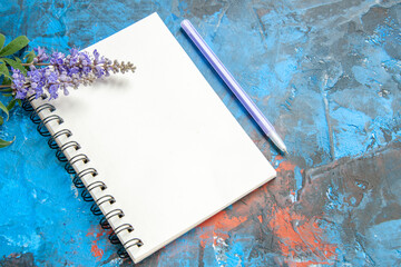 bottom view a notebook a pen on blue background free space