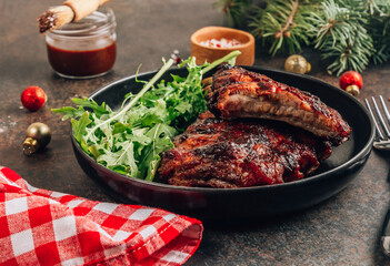 Homemade barbecued ribs seasoned with a spicy basting sauce. Christmas concept