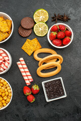 top view different eatings crackers fruits and candies on dark background photo sweet tea crisp