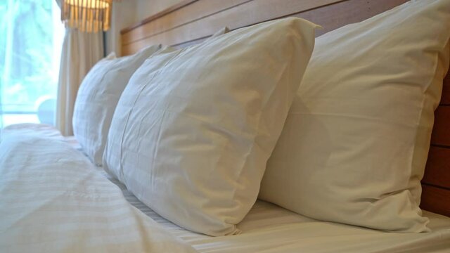 white pillow decoration on bed in bedroom interior
