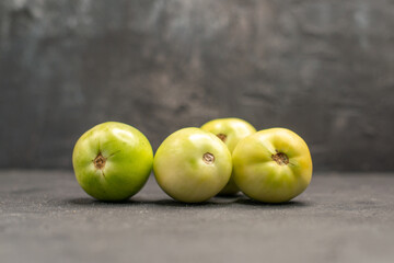 Top view of fresh green vegetables on dark background