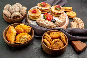 front view yummy pancakes with fruits and sweet cakes on dark background dessert sweet cake